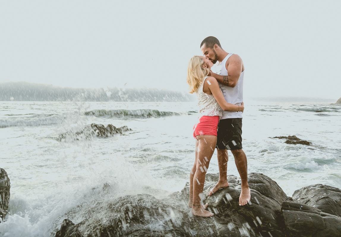 mallorca beach engagement photographer - waves splashing around kissing couple